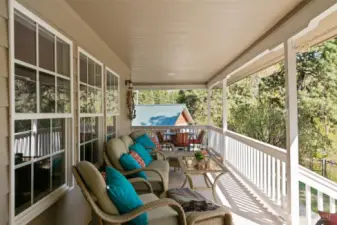 Covered deck with garage in background.