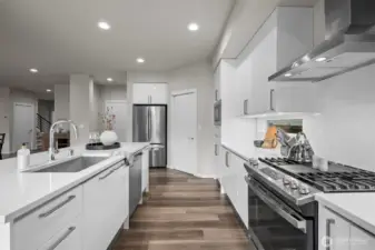 The builder did not cut corners: piano finish soft close cabinetry w/ pull-down shelving, cabinet organizers, trash/recycle bins, under cabinet lighting etc.