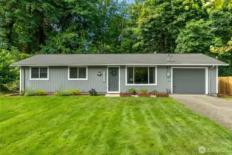 The lush, green front yard features pretty, low maintenance landscaping and the private, peaceful backyard, is cleared and ready for hydroseed and your creativity!