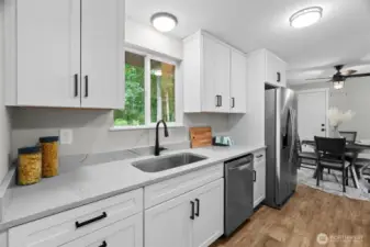 Love this fully updated Kitchen with stunning quartz counters, solid wood, soft-close cabinetry, contemporary hardware and lighting and stainless steel appliances!