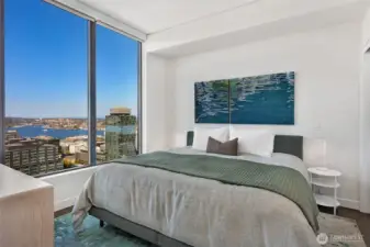 The comfort of your bedroom is the perfect vantage point to watch the sun set behind the Space Needle over Elliot Bay.