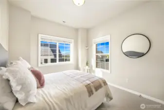 The second bedroom with partial mountain views and a walk-in closet