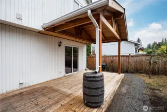 Covered deck with a rain barrel