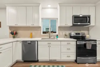 Quartz countertops, lots of cabinets, stainless steel appliances.