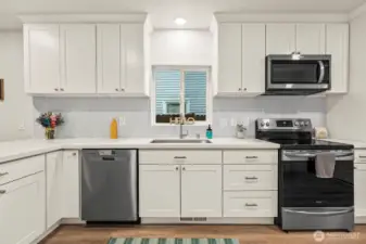 Quartz countertops, lots of cabinets, stainless steel appliances.