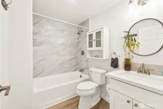 Main floor full bath. New cabinetry and quartz countertops.
