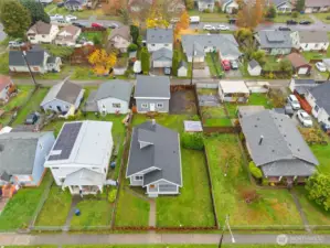 Aerial view of home. Spacious lot. Newer roof, 75 year foundation warranty, new sewer line.