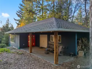 Studio patio. French doors lead to finished storage room w/concrete flooring. Catchment system is just below with the filtration system in the storage room.