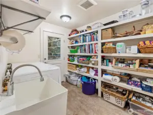 pantry/laundry room. Door leads to deck. Another door to the garage not shown. Standing in door to livingroom/kitchen area