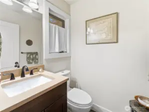 Half-bath at bottom of stairs just outside of foyer. Great for guests.