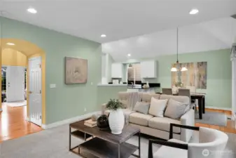 Breakfast area with upgraded breakfast countertop with full bullnose finished edge. Oak-hardwood floor. Alabaster-style chandelier. Sliding glass door with two-inch blinds, and screen door that opens to large aggregate patio and bordered by pavers. Very private, fully-fenced Arboretum-style backyard, with wonderful water feature. Family room off the kitchen-breakfast area, with adjustable lighting. Hallway with barrel ceiling to powder bath and laundry room.