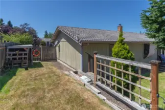 Side yard with wood shed and more room for plants.