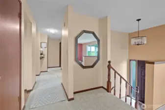 Upstairs hall with stairs to front door.