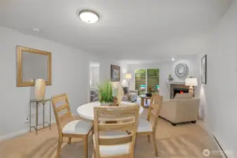 The dedicated dining area sits centrally between kitchen and living room, benefiting from ample wall space for art and flexible furniture arrangements under updated lighting.