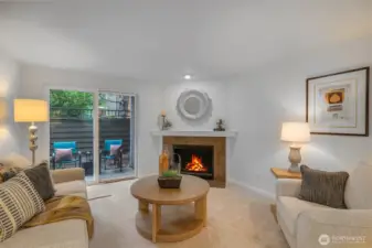The living room is anchored by a granite-trimmed wood burning fireplace and enjoys direct access to a private patio through sliding glass doors—perfect for indoor-outdoor relaxation in Kirkland’s desirable Moss Bay neighborhood.