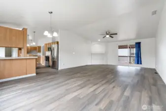 Large open living room with slider to covered deck.