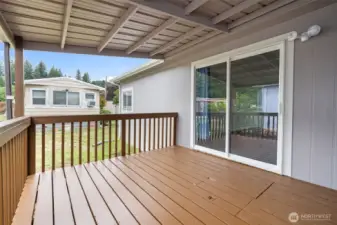Covered deck off living room .