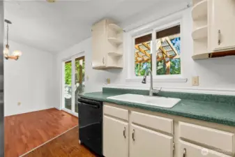 Kitchen looking toward dining area and sliding glass doors to rear covered deck