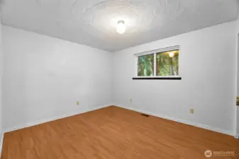 Second bedroom (unstaged). No carpet makes cleaning a breeze!