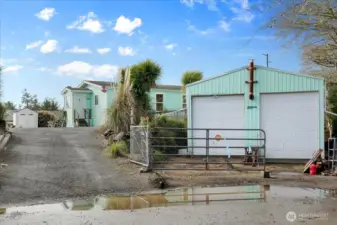 Street view of home and shop with loft and room for RV storage.