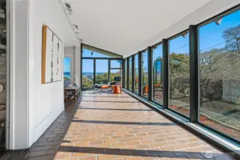 A wall of windows lets the natural light in as you enter the Sun Porch.  This flexible space has been used as a dining area as well as an extra lounge.