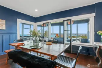 The spacious formal dining room blends classic features like wainscoting with modern easy care flooring. It's perfect for entertaining!  There is direct access to the Sun Room and the layout takes full advantage of the views.