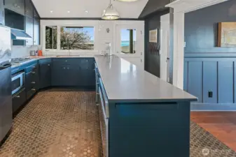 The kitchen has modern Hex tile flooring and plenty of counterspace for food prep! There is direct access from the vintage style Dutch door out to the large deck.  Perfect for Summer BBQ's.