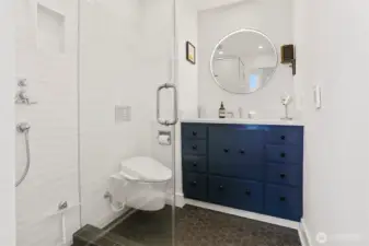 Stylish newer primary bathroom features designer fixtures, Hex tiles with cozy in-floor radiant heat and Quartz countertop.