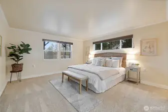 This is the downstairs primary bedroom with its own full bath and large walk in closet. Peek a boo water views too!