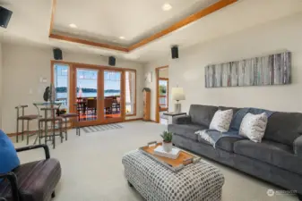 Great room with built in speakers and French doors out to the lakeside deck.