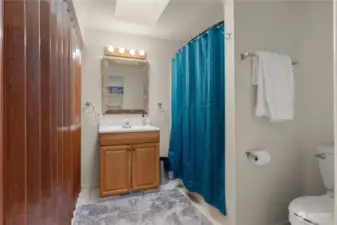 Full bathroom with additional storage off the family room