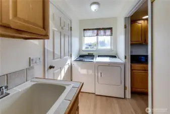 Laundry room is just off the kitchen and adjacent to the door to the garage. Home includes the washer and dryer.