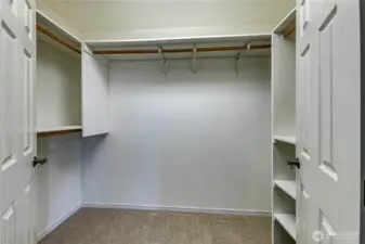 Well organized walk-in closet in the primary bedroom.