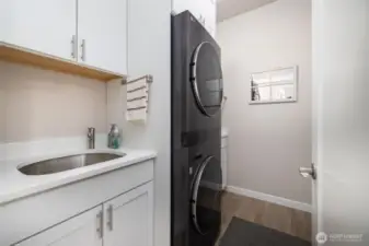 The utility was customized with matching cabinets, a utility sink and stackable steam washer/dryer that stays!