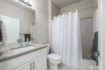 Main bath has taller cabinets with quartz counters & a taller toilet.