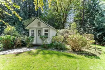 Large quaint shed in garden.