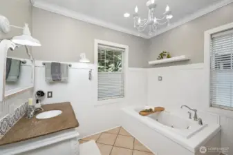 Featuring a soaking tub, tiled shower and tile floors, the primary bathroom is truly a place of zen.