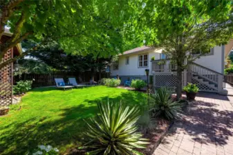 Fully fenced in, the yard is a canvas of curated landscaping, creating the perfect escape after a long day.