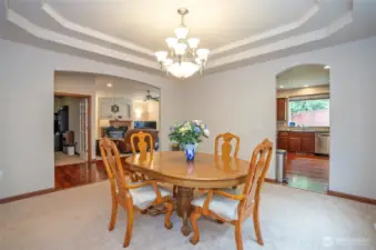 From the dining room, take in the bright, open flow leading to the kitchen on the right and the inviting family room and flexible den or office to the left.
