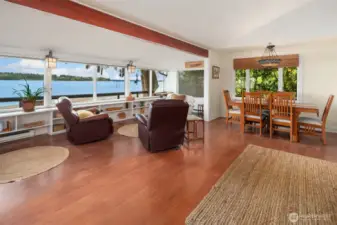 Great room on upper floor has space for lounging, reading, dining and cozying up by the fireplace.