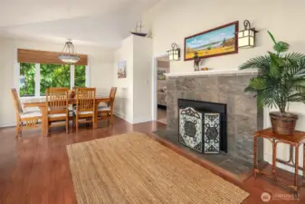 Great room has a wood burning fireplace and a sweet dining are on the side.