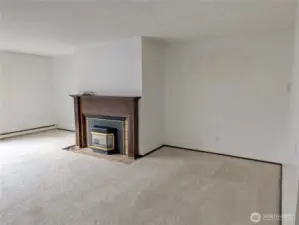 Large living rm with wood fireplace. Welcome to #11214 34th Ave E, Tacoma WA 98446. 3200+sf, 4+ br, 3 ba, 1.1 fenced acres.