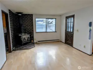 Family rm with wood stove, adjacent to the kitchen, Laundry rm & 3/4 bath. Welcome to #11214 34th Ave E, Tacoma WA 98446. 3200+sf, 4+ br, 3 ba, 1.1 fenced acres.