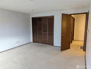 Prinmary bedroom. with walk in closet & primary bathroom. Welcome to #11214 34th Ave E, Tacoma WA 98446. 3200+sf, 4+ br, 3 ba, 1.1 fenced acres.