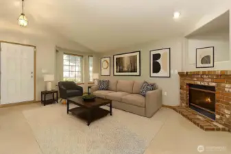 Cathedral ceilings  enhance bright living room with warm gas fireplace