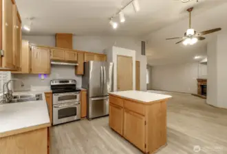 Kitchen looks out to yard and patio