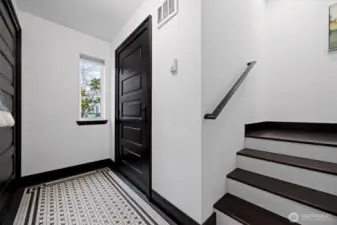The spacious entryway offers space for hanging coats & bags plus there is a sweet built in shelf perfect for key storage etc. The door on the left opens to the garage