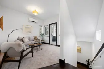 There is new paint & carpet throughout! The door opens to a sweet patio and there is wiring for a wall mounted TV to the right of the stairs