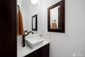 Privately situated 1/2 bath off the laundry room