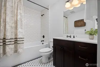 Full bath with beautiful tile and an extra deep tub perfect for soaking